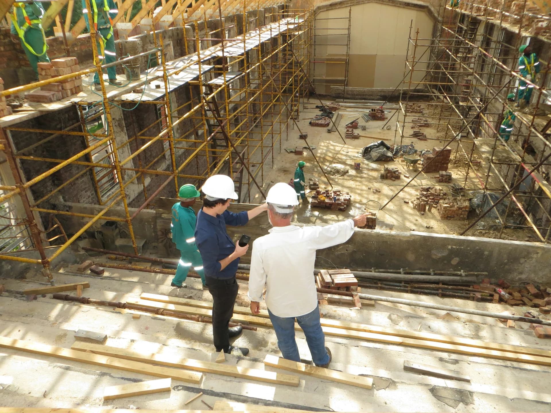 Environmental inspection team examining the interior of a commercial building during a Phase 1 ESA site reconnaissance